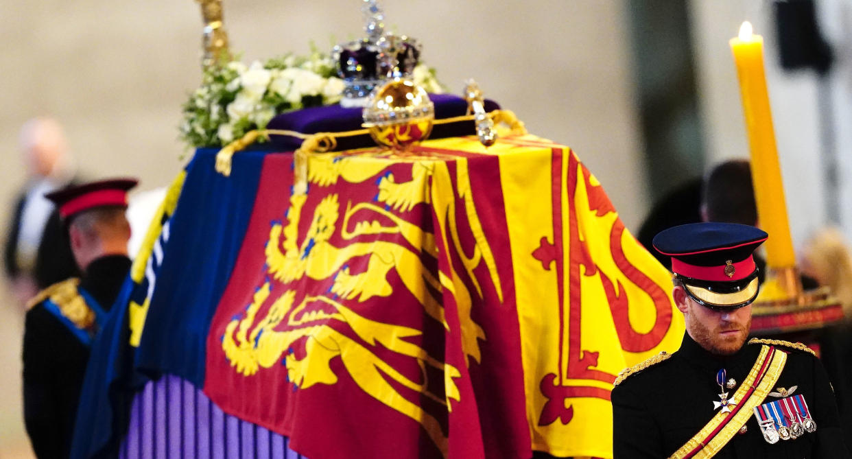 Prince Harry and Prince William stand next to the Queen's coffin