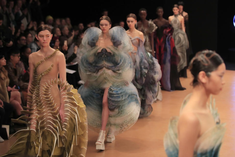 Models wear creations for Iris van Herpen Haute Couture Spring/Summer 2020 fashion collection presented Monday Jan.20, 2020 in Paris (AP Photo/Michel Euler)