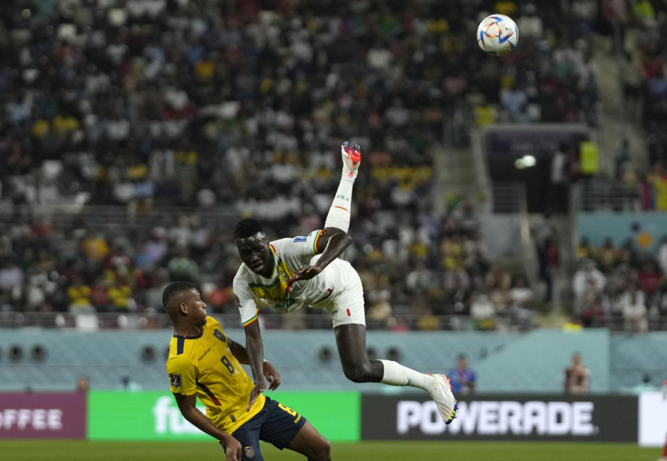 Ecuador's Carlos Gruezo, left, and Senegal's Pape Gueye vie for the ball during the World Cup group A soccer match between Ecuador and Senegal, at the Khalifa International Stadium in Doha, Qatar, Tuesday, Nov. 29, 2022. (AP Photo/Themba Hadebe)