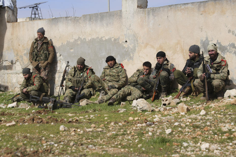 Turkish backed fighter prepare to go to the frontline in the Syrian province of Idlib, Monday, Feb. 10, 2020. The fighting in Idlib led to the collapse of a fragile cease-fire that was brokered by Turkey and Russia in 2018. Turkey supports the Syrian rebels, while Russia has heavily backed the Syrian government's campaign to retake the area which is the last rebel stronghold in Syria. (AP Photo/Ghaith Alsayed)