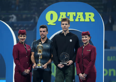 Tennis - ATP - Qatar Open - Khalifa International Tennis and Squash Complex, Doha, Qatar - January 5, 2019 Spain's Roberto Bautista Agut and Czech Republic's Tomas Berdych celebrate with their trophies after Roberto Bautista Agut wins the final REUTERS/Ibraheem Al Omari