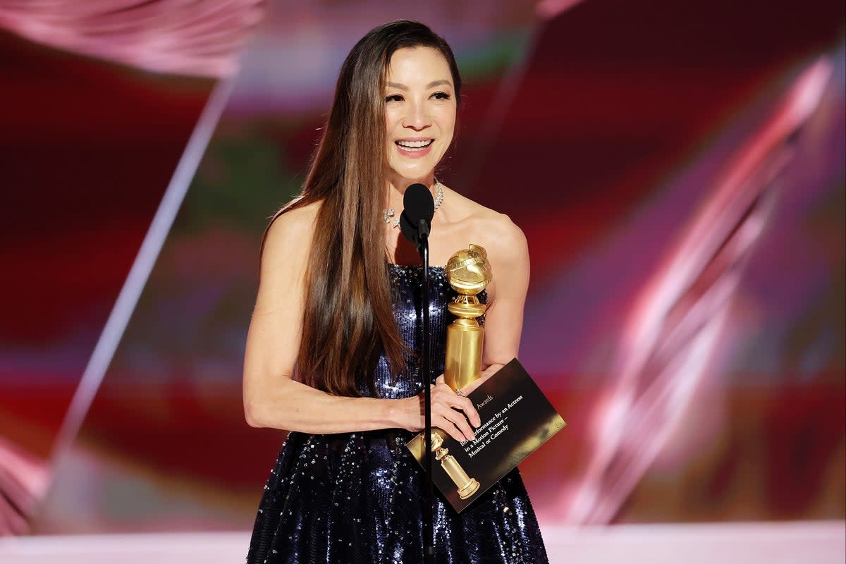 Michelle Yeoh accepts a Golden Globe  (Getty Images)