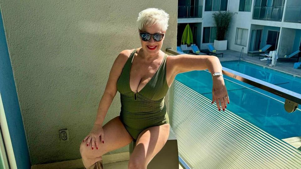 Denise Welch in a swimsuit and cowboy boots