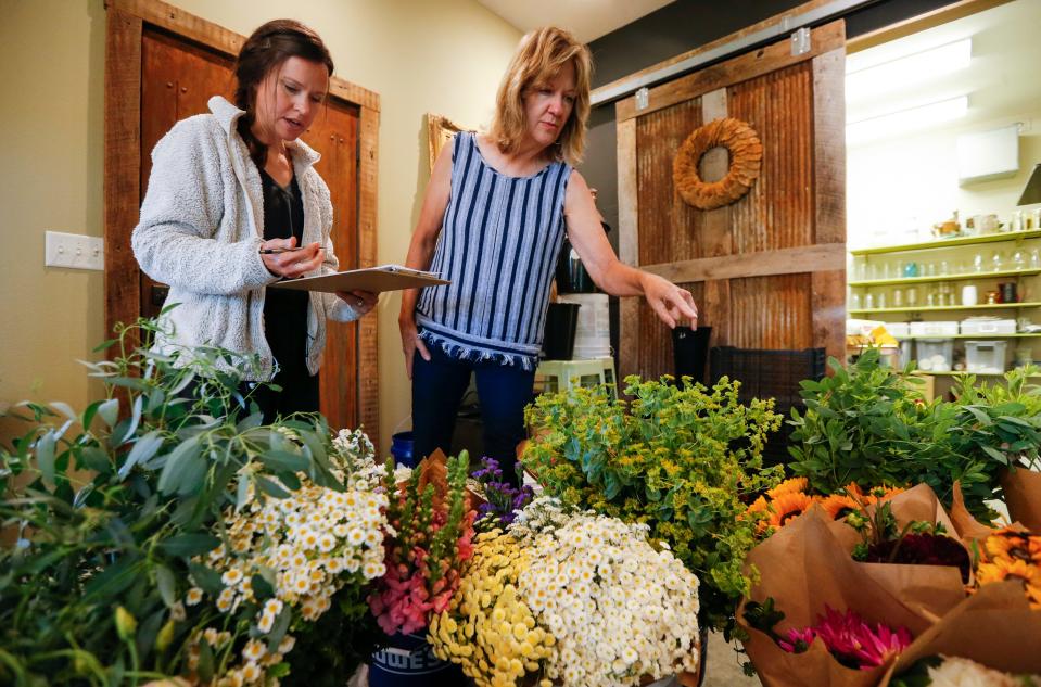 Angela Morton (left) and Ginny Randall, two of the founders of the Missouri Flower Exchange, check to make sure an order has all the flowers ordered on Wednesday, June 28, 2023.