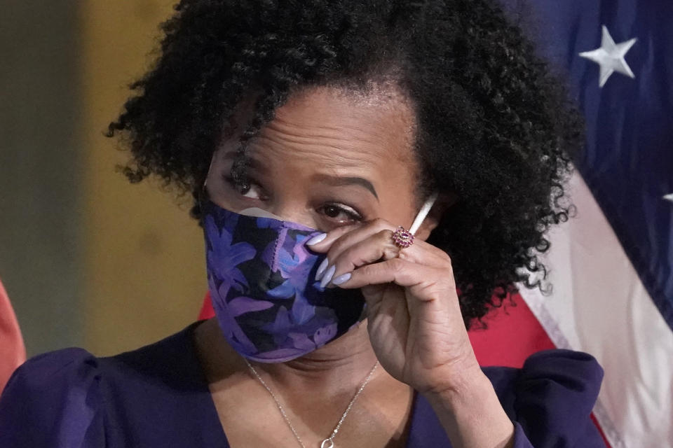 Former Boston City Council President Kim Janey, 55, wipes a tear as she is introduced to be sworn in as Boston's new mayor at City Hall, Wednesday, March 24, 2021, in Boston. Janey, who is the city's first female and first person of color to take the office, replaces Marty Walsh who resigned Monday evening to become President Joe Biden's labor secretary. (AP Photo/Elise Amendola)