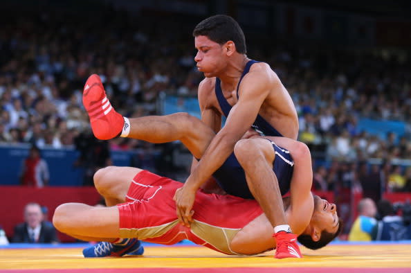 LONDON, ENGLAND - AUGUST 06: Zaur Kuramagomedov of Russia competes with Tarek Aziz Benaissa of Algeria (top) during their Men's Greco-Roman 60 kg Wrestling 1/8 Final bout on Day 10 of the London 2012 Olympic Games at ExCeL on August 6, 2012 in London, England. (Photo by Cameron Spencer/Getty Images)