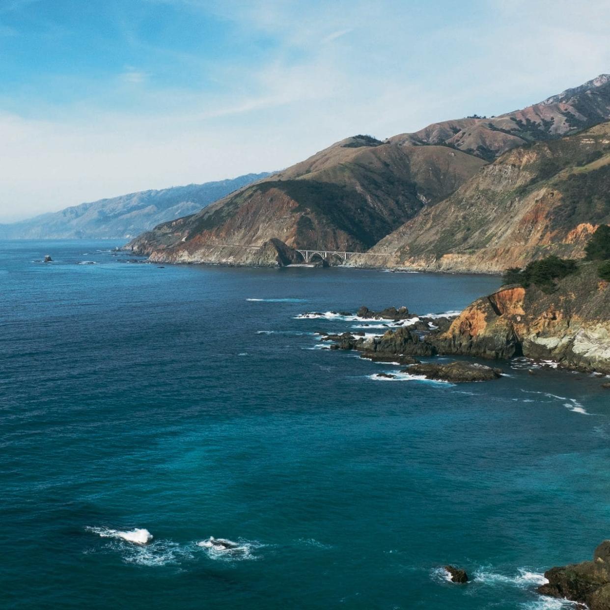 Highway 1 snakes along the West Coast, with Bixby Creek Bridge, Monterey, in the distance - Farhad Samari