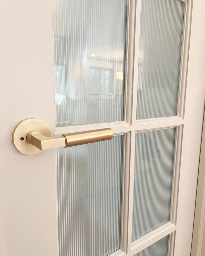 Close-up look at glass panes in French door, which have been covered in reeded glass window film