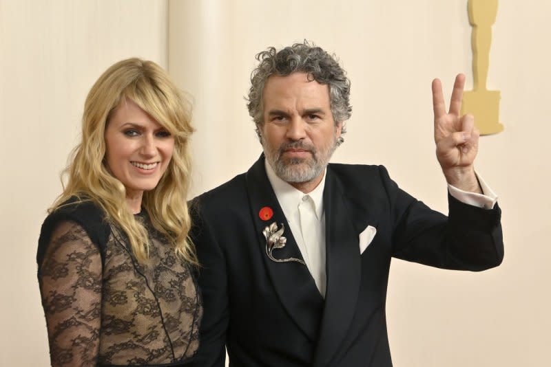Mark Ruffalo (R) and Sunrise Coigney arrive on the red carpet at the Academy Awards in Los Angeles on Sunday. Ruffalo wore a red pin to the ceremony, which calls for a ceasefire in the Israel-Hamas war. Photo by Jim Ruymen/UPI