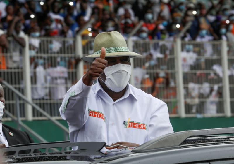 Ivory Coast President Alassane Ouattara waves as he arrives for the meeting of the ruling coalition party RHDP organised to nominate him to stand for a third term in October's election in Abidjan