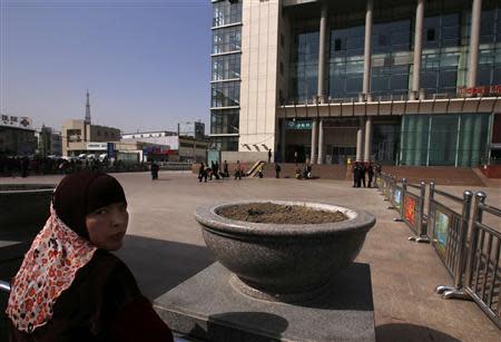 A Uighur woman looks back near exit of the South Railway Station, where three people were killed and 79 wounded in Wednesday's bomb and knife attack, in Urumqi, Xinjiang Uighur Autonomous region, May 2, 2014. REUTERS/Petar Kujundzic