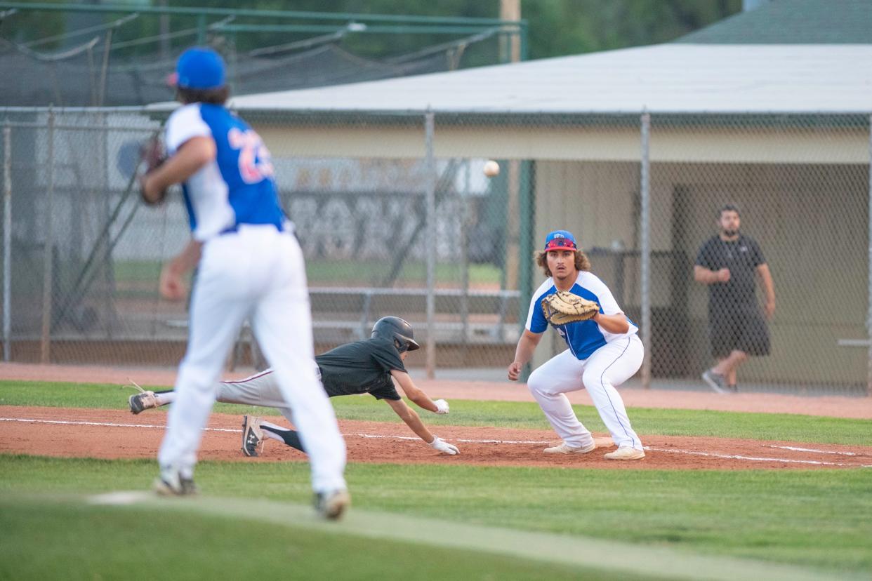 Pueblo Azteca’s Trevor Thomas, right, awaits the ball on a pickoff attempt of a Grand Junction runner during the 2021 Tony Andenucio Memorial Tournament at the Runyon Sports Complex.