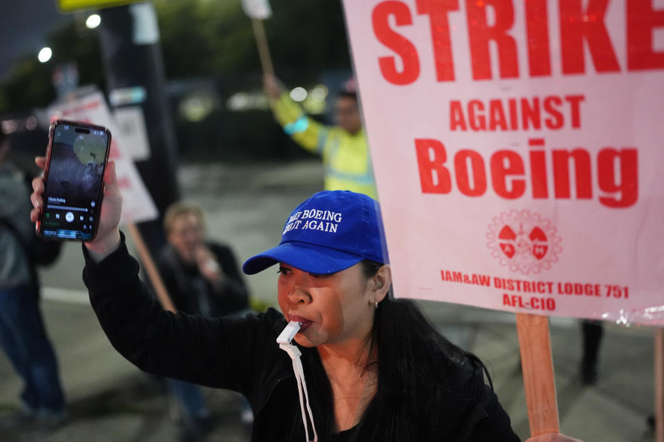 Boeing employee Ritz Amador, 40, who works as a customer coordinator, wears a "Make Boeing Great Again" cap while picketing after union members voted overwhelmingly to reject a contract offer and go on strike Friday, Sept. 13, 2024, outside the company's factory in Renton, Wash. (AP Photo/Lindsey Wasson)