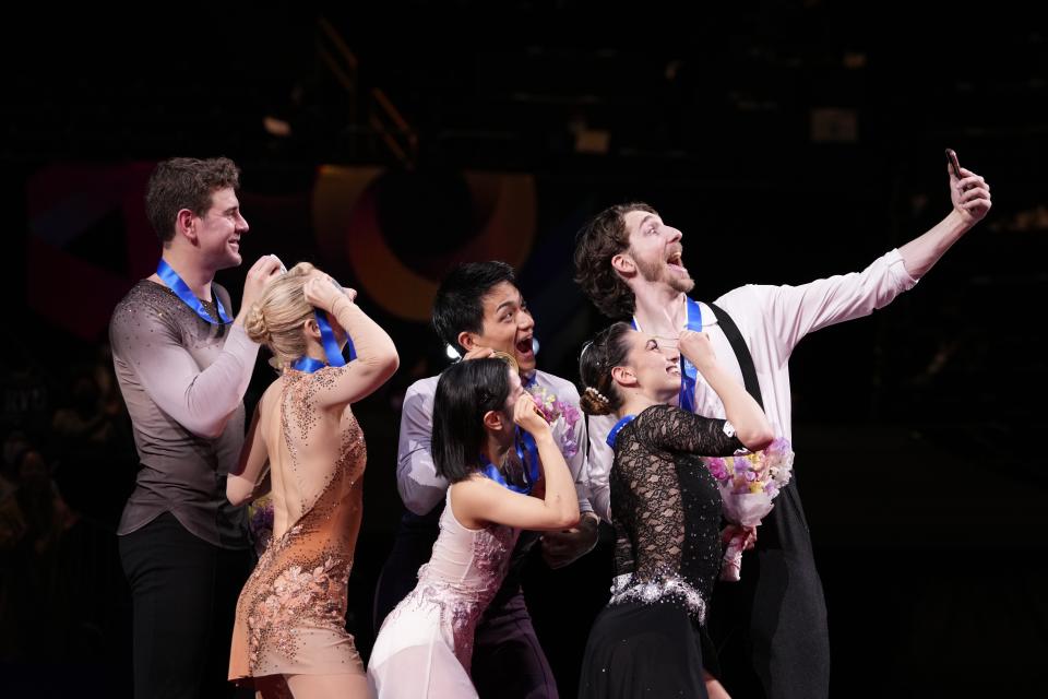 Riku Miura and Ryuichi Kihara of Japan, center, with gold medals, Alexa Knierim and Brandon Frazier of the U.S., left, with silver medals, and Sara Conti and Niccolo Macii of Italy, with bronze medals, pose for a selfie at the end of the award ceremony for the pairs' free skating program in the World Figure Skating Championships in Saitama, north of Tokyo, Thursday, March 23, 2023. (AP Photo/Hiro Komae)