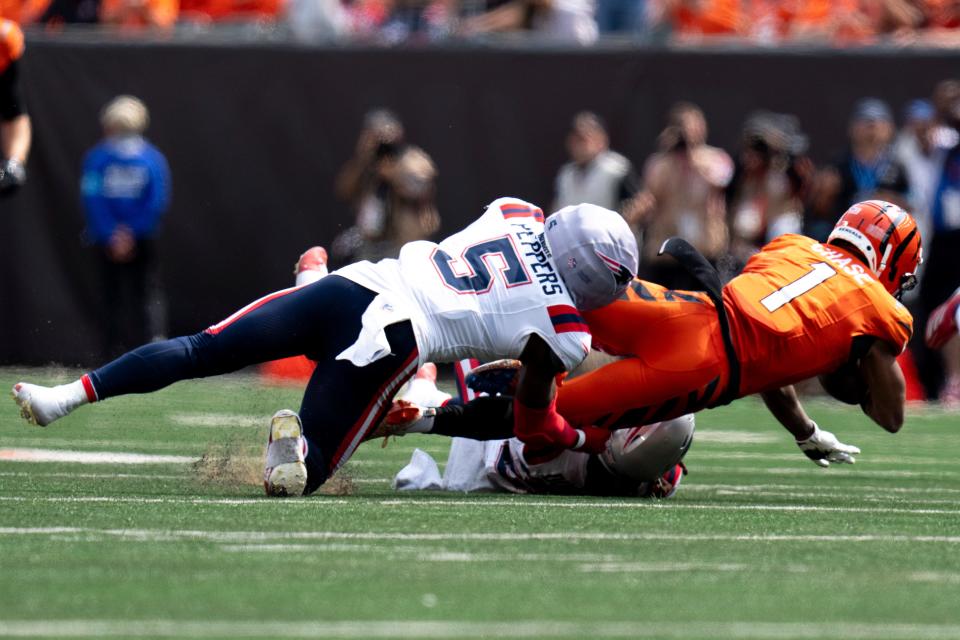 New England Patriots safety Jabrill Peppers (5) tackles Cincinnati Bengals wide receiver Ja'Marr Chase (1) in the fourth quarter of the NFL game against the Cincinnati Bengals at Paycor Stadium in Cincinnati on Sunday, Sept. 8, 2024.