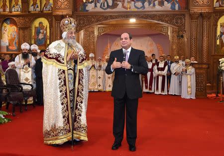 Egyptian Coptic Pope Tawadros II (L), Pope of the Coptic Orthodox Church of Alexandria, and Patriarch of Saint Marc Episcopate receives Egyptian President Abdel Fattah al-Sisi (R), at the new Coptic Cathedral at the new Coptic Cathedral "The Nativity of Christ" in the new administrative capital, 45km east of Cairo, Egypt January 6, 2018, in this handout picture courtesy of the Egyptian Presidency. The Egyptian Presidency/Handout via REUTERS