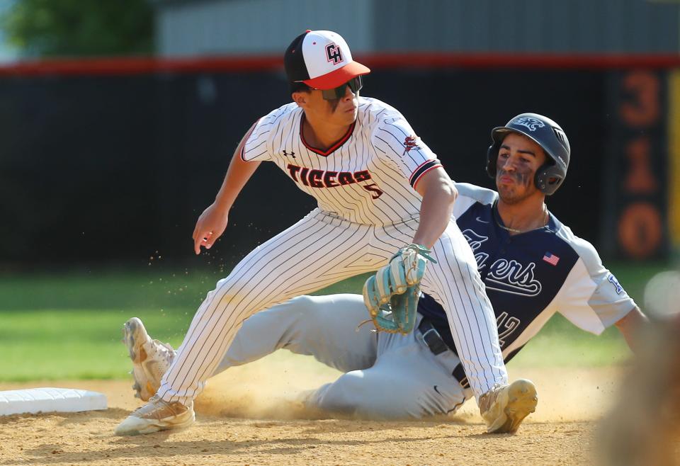 Putnam Valley's Ricky Meister (12) slides safe into second with a stolen base as Croton's Ryan Kim covers the bag during baseball action at Croton-Harmon High School May 3, 2024. Putnam Valley won the game 5-1.