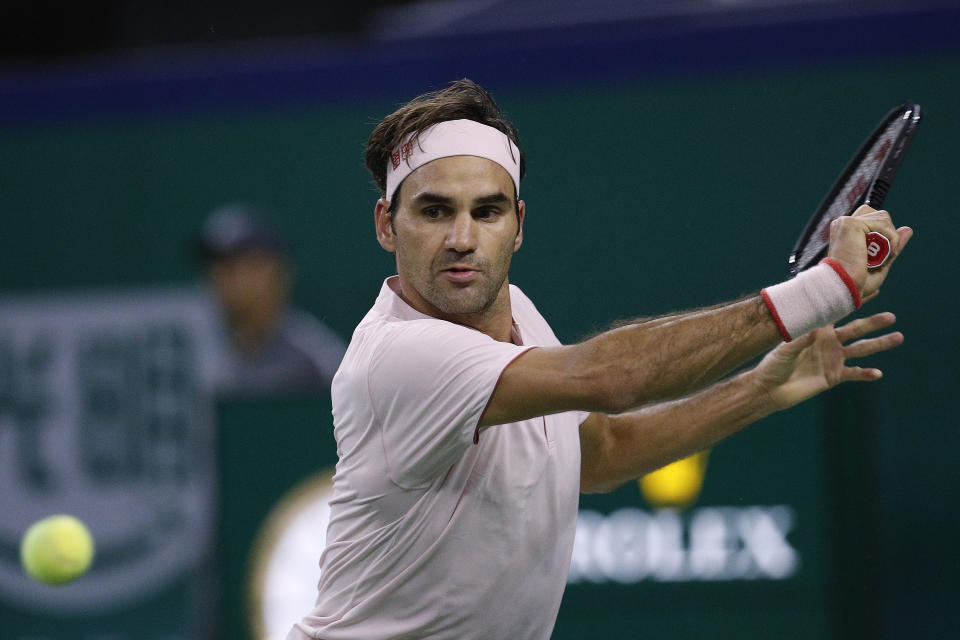 Roger Federer of Switzerland prepares to hit a return shot to Kei Nishikori of Japan during their men's singles quarterfinals match in the Shanghai Masters tennis tournament at Qizhong Forest Sports City Tennis Center in Shanghai, China, Friday, Oct. 12, 2018. (AP Photo/Andy Wong)