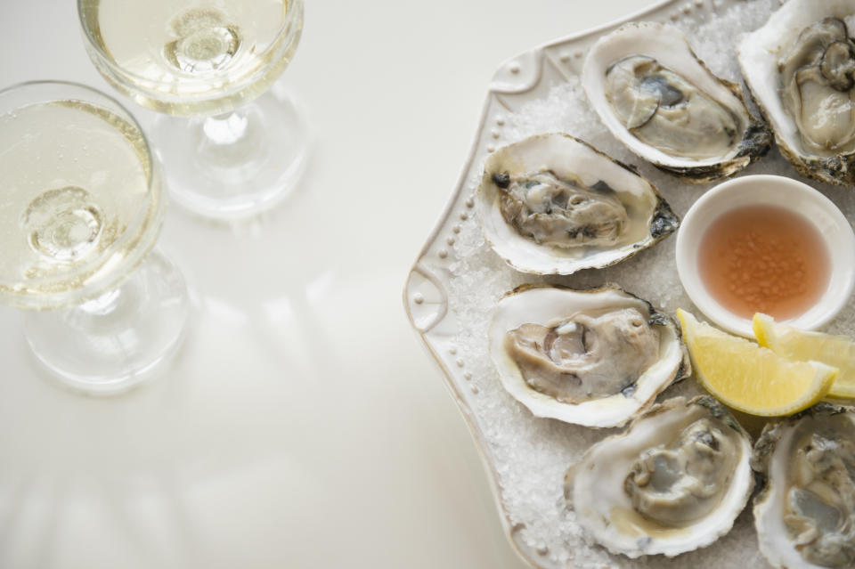 Mignonette (seen in the center of the oysters) is a classic sauce made of red wine vinegar and minced shallot. (Photo: Jamie Grill via Getty Images)