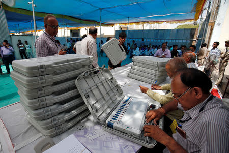 A member of election staff checks an Electronic Voting Machine (EVM) at a distribution centre ahead of India's general election, in Ahmedabad, India, March 26, 2019. REUTERS/Amit Dave