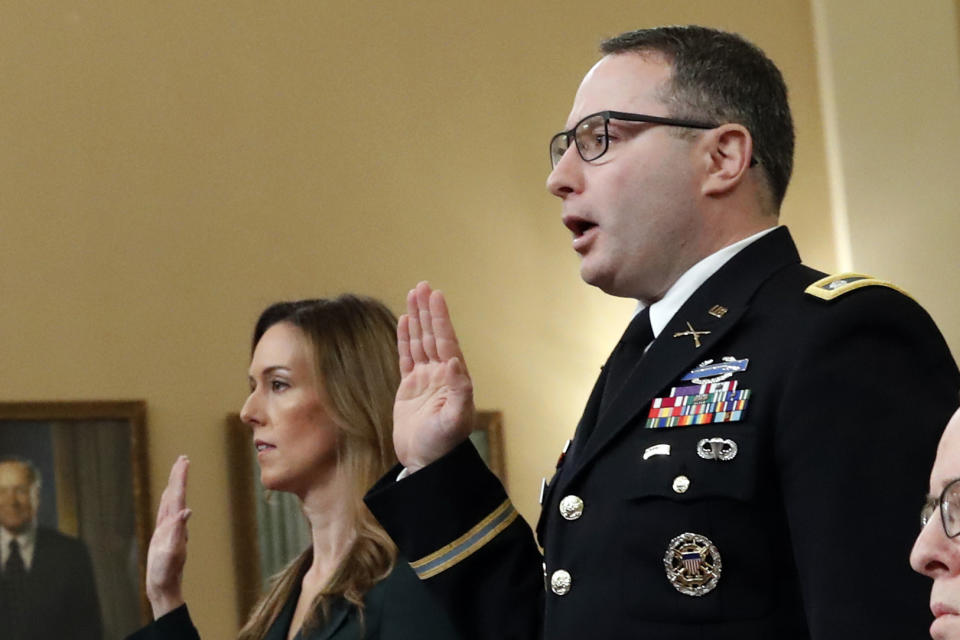 Jennifer Williams, an aide to Vice President Mike Pence, and National Security Council aide Lt. Col. Alexander Vindman, are sworn in before they testify before the House Intelligence Committee on Capitol Hill in Washington, Tuesday, Nov. 19, 2019, during a public impeachment hearing of President Donald Trump's efforts to tie U.S. aid for Ukraine to investigations of his political opponents. (AP Photo/Alex Brandon)