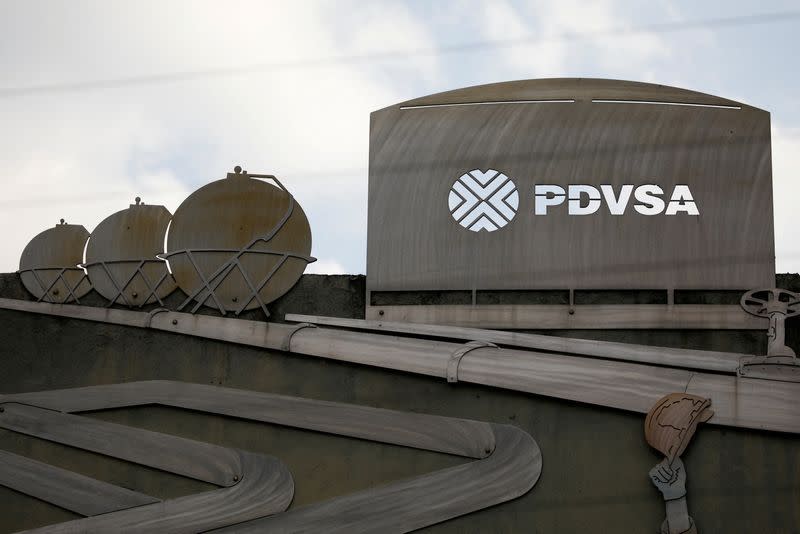 FILE PHOTO: Cutouts depicting images of oil operations are seen outside a building of Venezuela's state oil company PDVSA in Caracas
