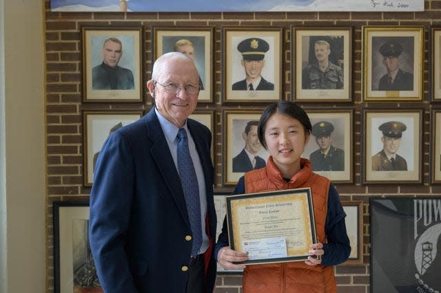 Jesse Jin, a Council Rock senior, receives a certificate and scholarship from thelegacyof1776.com editor Dick Newbert.