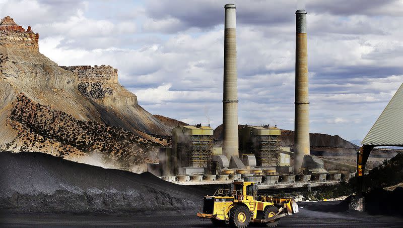 A loader moves coal at the Huntington power plant in Huntington, Tuesday, March 24, 2015.