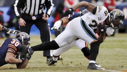 Former Jaguars running back Fred Taylor, right, says NFL doctors didn't reveal injuries to him (AP).