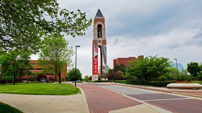 Muncie, Indiana / United States - May10, 2019 Ball State University Shafer Bell Tower with road, sidewalk, trees and overcast sky in springtime.