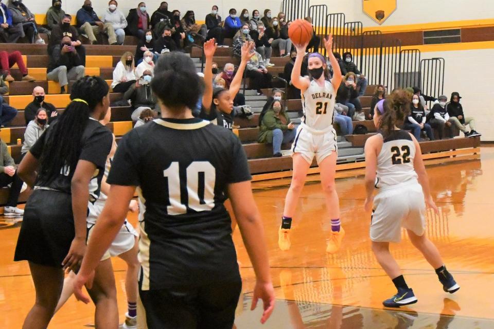 Delran junior Riley Ahrens takes off for a 3-pointer against Burlington Township