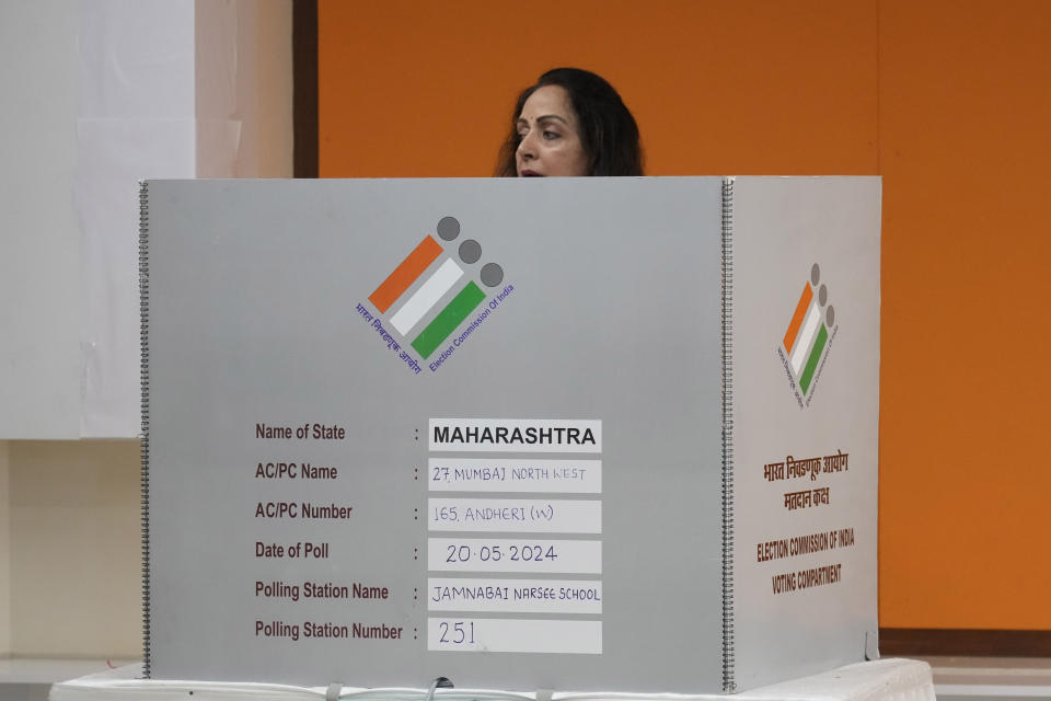 Indian actress Hema Malini casts her vote at a polling booth during the fifth round of multi-phase national elections in Mumbai, India, Monday, May 20, 2024. (AP Photo/Rafiq Maqbool)