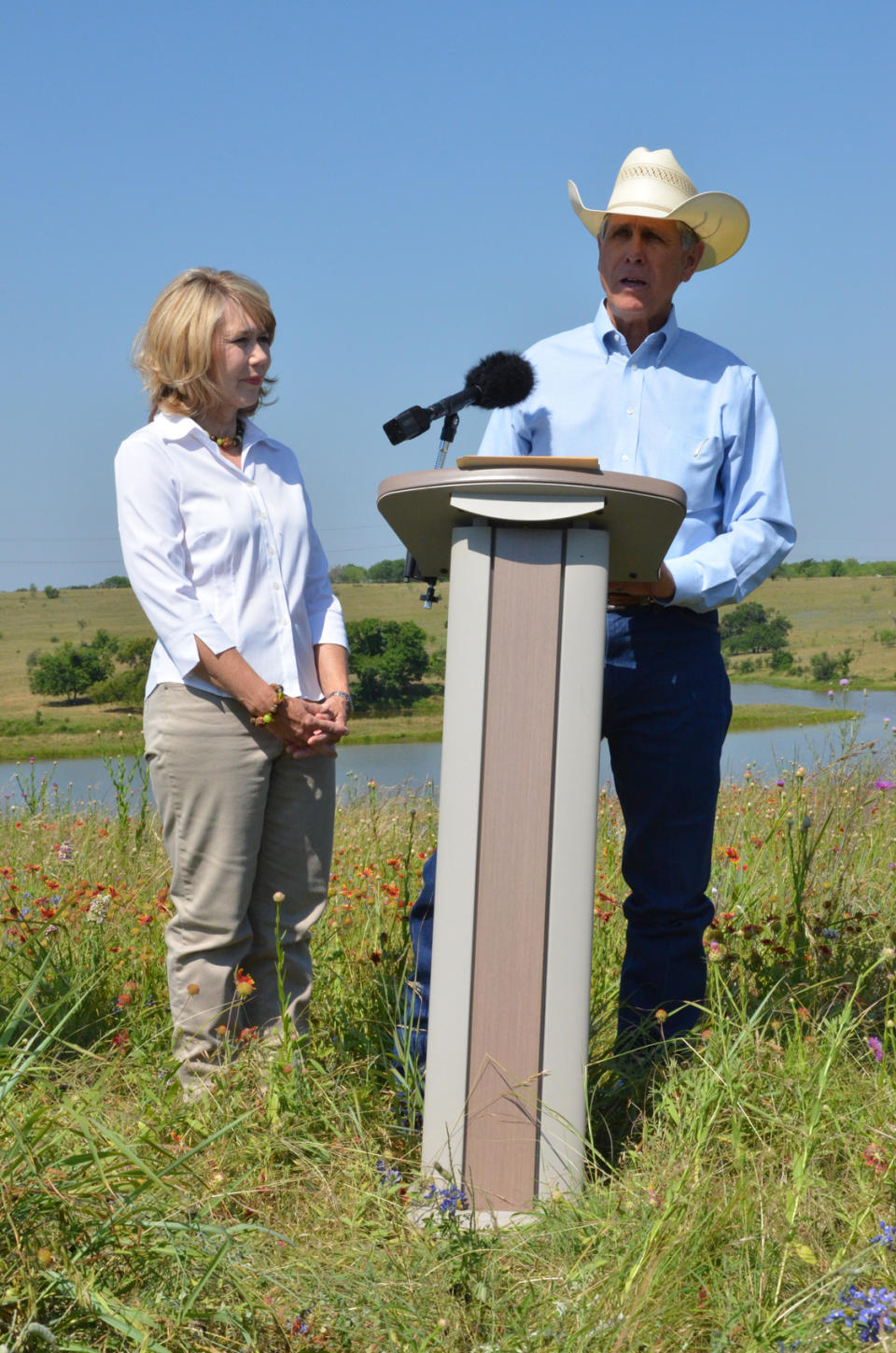 In this photo provided by USDA-Natural Resources Conservation Service, Gary, right, and Sue Price host federal, state and local soil and water conservation officials on their land in Navarro County near Corsicana, Texas Thursday, May 17, 2012 to talk about how a new national initiative to improve watersheds would work in Texas. A national water quality initiative will provide $2.8 million in funding to farmers, ranchers and timberland owners along a major watershed of the Trinity River Basin to encourage conservation practices that will have a positive impact on Texas' rivers, lakes and streams. (AP Photo/USDA-Natural Resources Conservation Service, Beverly Moseley)