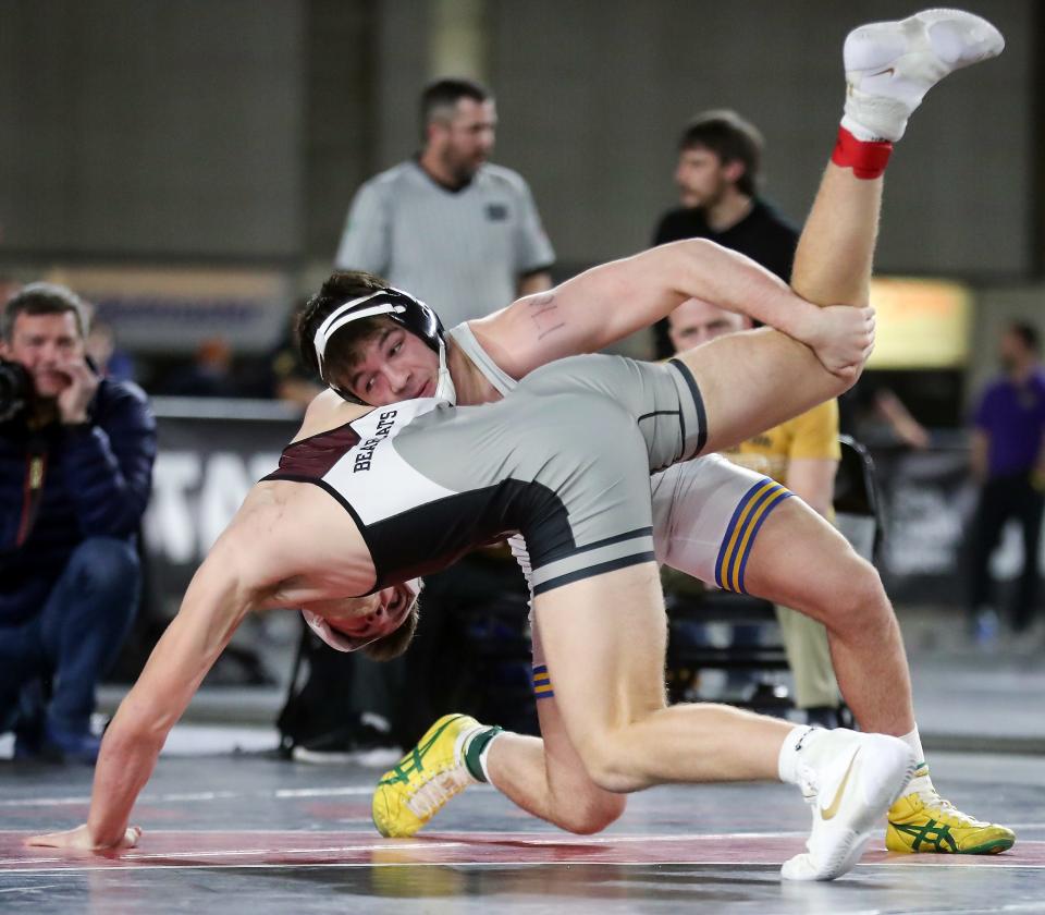 Bremerton’s Thor Michaelson wrestles WF West’s Tucker Land for their 170-pound championship bout during the Mat Classic Championships at the Tacoma Dome on Saturday, Feb. 18, 2023. 