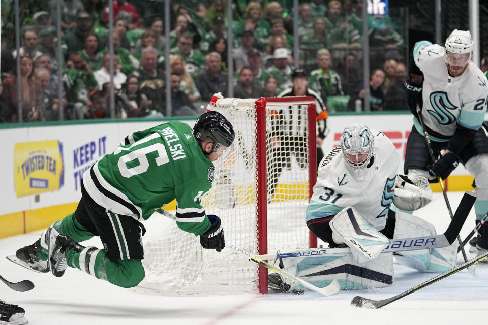 Dallas Stars center Joe Pavelski (16) attempts to score against Seattle Kraken goaltender Philipp Grubauer from behind the net in the first period of Game 1 of an NHL hockey Stanley Cup second-round playoff series, Tuesday, May 2, 2023, in Dallas. (AP Photo/Tony Gutierrez)