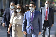 Former Fall River, Mass. Mayor Jasiel Correia, right, and his wife Jenny Fernandes, left, arrive for a court appearance at the John Joseph Moakley United States Courthouse, Monday, Sept. 20, 2021, in Boston. Correia, who was elected at the age of 23 with promises to rejuvenate the struggling mill city, was scheduled to be sentenced for stealing from investors in a smartphone app he created and extorting hundreds of thousands of dollars in bribes from marijuana businesses. (AP Photo/Josh Reynolds)