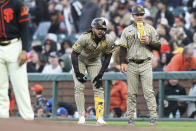 San Diego Padres' Fernando Tatis Jr., center, reacts to a play against the San Francisco Giants in the third inning of a baseball game in San Francisco, Saturday, April 6, 2024. (AP Photo/Kavin Mistry)