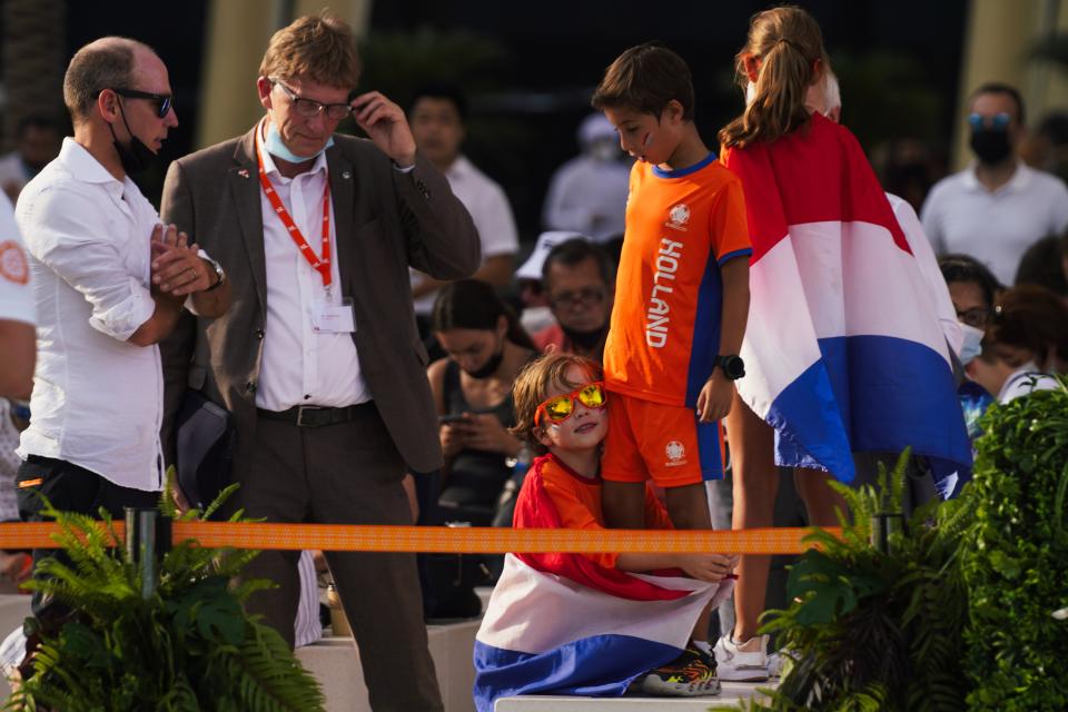 A young boy draped in the Netherlands' flag hugs another boy at Expo 2020 in Dubai, United Arab Emirates, Wednesday, Nov. 3, 2021. King Willem-Alexander and Queen Maxima of the Netherlands are in the United Arab Emirates as part of a royal trip to the country to visit Dubai's Expo 2020. (AP Photo/Jon Gambrell)