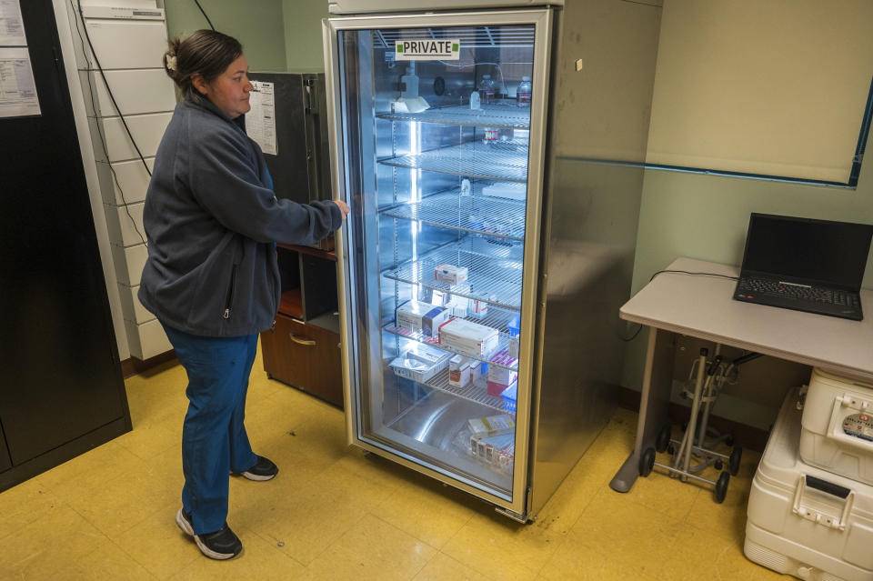 Lead medical assistant Beatriz Nunez organizes vaccines at Alliance Medical Center in Healdsburg, Calif., Wednesday, May 29, 2024. During the 2017 Tubbs fire, the refrigerators used to store medications stopped working, destroying $30,000 worth of vaccines. (AP Photo/Nic Coury)