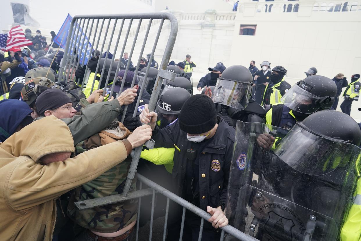 WASHINGTON, DC - JANUARY 06:  Police try to hold back protesters who  gather storm the Capitol and halt a joint session of the 117th Congress on Wednesday, Jan. 6, 2021 in Washington, DC. (Kent Nishimura / Los Angeles Times via Getty Images)