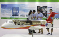 FILE PHOTO: A model of the ARJ21 regional jet from Commercial Aircraft Corp of China (COMAC) is displayed at the Aviation Expo China 2015 in Beijing, China, September 16, 2015. REUTERS/Jason Lee/File Photo