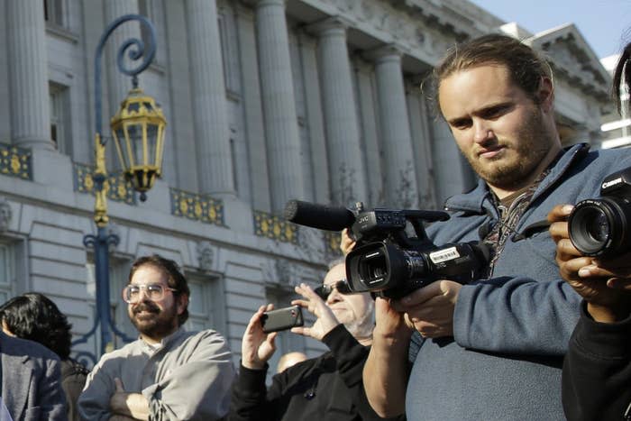 David DePape (right) records the nude wedding of Gypsy Taub outside San Francisco City Hall on Dec. 19, 2013.
