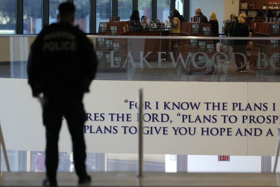 A police officer stands at the top of the steps inside Lakewood Church, Sunday, Feb. 18, 2024, in Houston. Pastor Joel Osteen welcomed worshippers back to Lakewood Church Sunday for the first time since a woman with an AR-style opened fire in between services at his Texas megachurch last Sunday. (AP Photo/David J. Phillip)