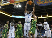 UCLA guard Jaylen Clark (0) and Oregon guard Will Richardson battle for a rebound during the first half of an NCAA college basketball game Sunday, Dec. 4, 2022, in Los Angeles. (AP Photo/John McCoy)