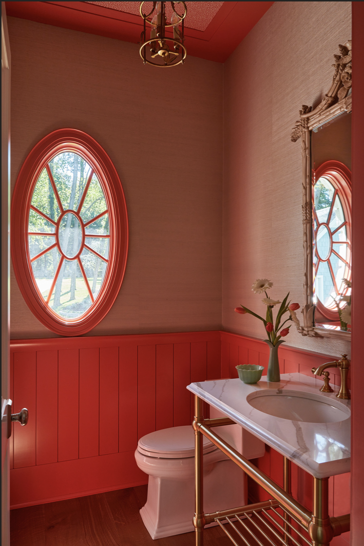 a bathroom with a red wall