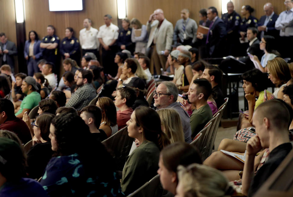 Protesters angered by a video of Phoenix officers who pointed guns and yelled obscenities at a black family they suspected of shoplifting gather inside City Council chambers, Wednesday, June 19, 2019, in Phoenix to demand reforms. Speakers called on the council to fire the officers involved in the videotaped incident and to create a board of civilians to oversee changes in department procedures. (AP Photo/Matt York)