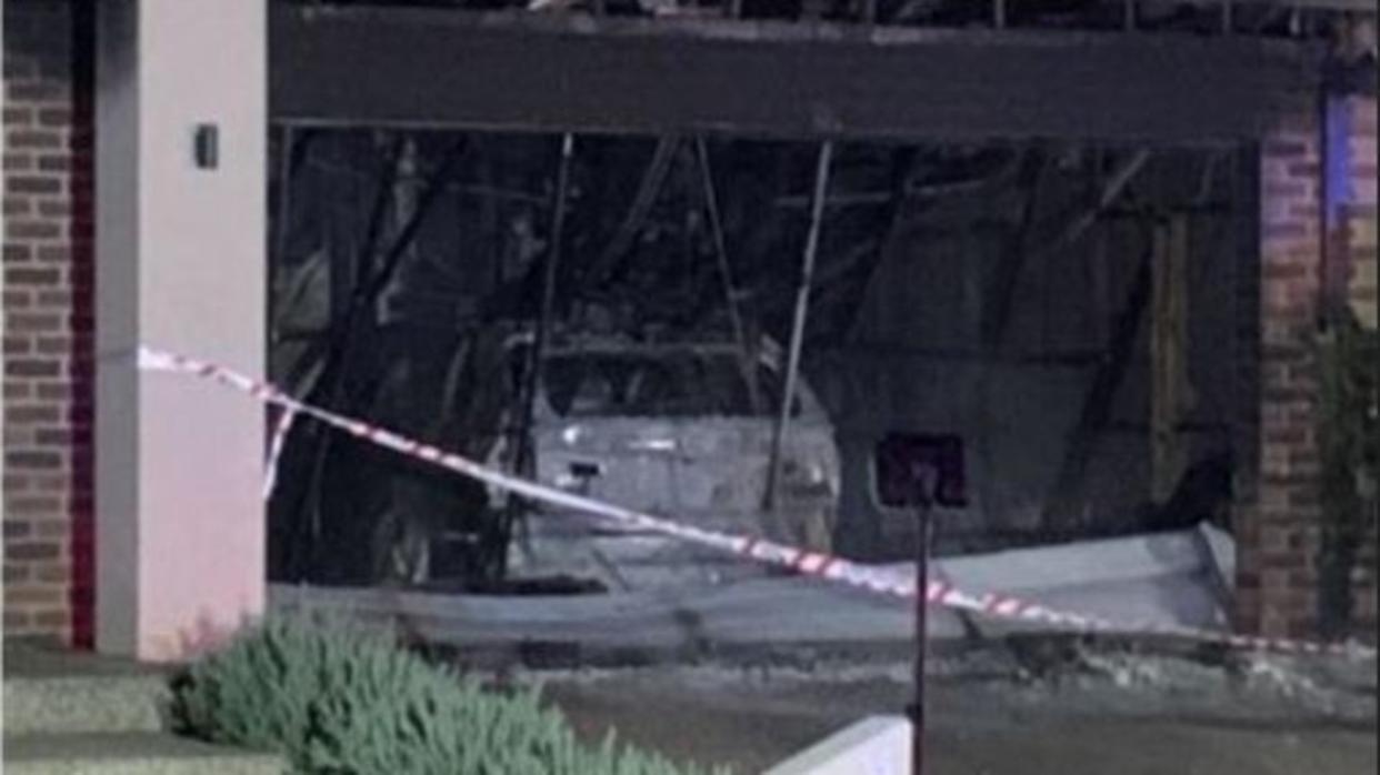 A police manhunt is under way in Victoria after a car ploughed through the garage of a house and sparked a dangerous blaze. Picture: 7News