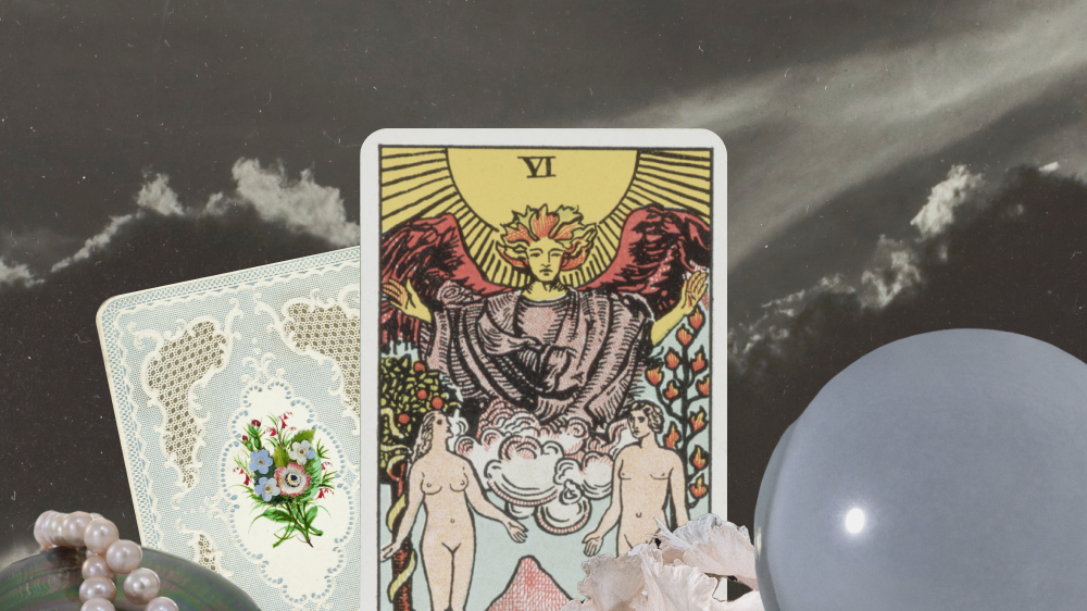 tarot cards surrounded by flowers, a crystal ball, and pearls