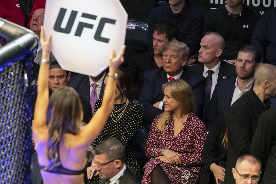 FILE - President Donald Trump looks on during UFC 244 mixed martial arts fights, Saturday, Nov. 2, 2019, in New York. Former President Donald Trump has spent less time campaigning in early-voting states than many of his Republican primary rivals. But his campaign has been bolstering his schedule with appearances at major sporting events. Video of his appearances routinely rack up hundreds of thousands of views across social media.(AP Photo/ Evan Vucci, File)