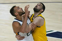 Indiana Pacers center Goga Bitadze, right, and Utah Jazz center Rudy Gobert (27) battle for position under the boards in the first half of an NBA basketball game Friday, April 16, 2021, in Salt Lake City. (AP Photo/Rick Bowmer)